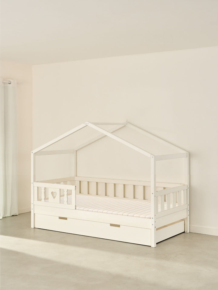 Lit cabane enfant blanc Paris Cabania, 1 barrière cœur et tiroir lit, couchage 90x190cm.