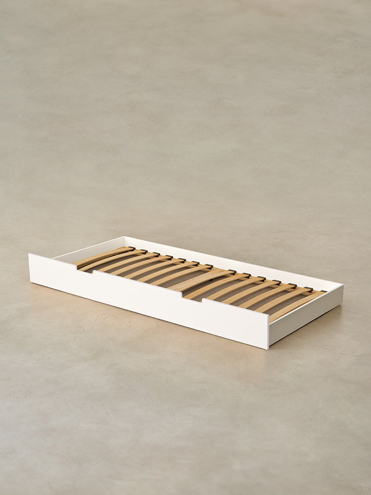 Cabania white children's bed with integrated storage drawer, ideal for minimalist bedroom.