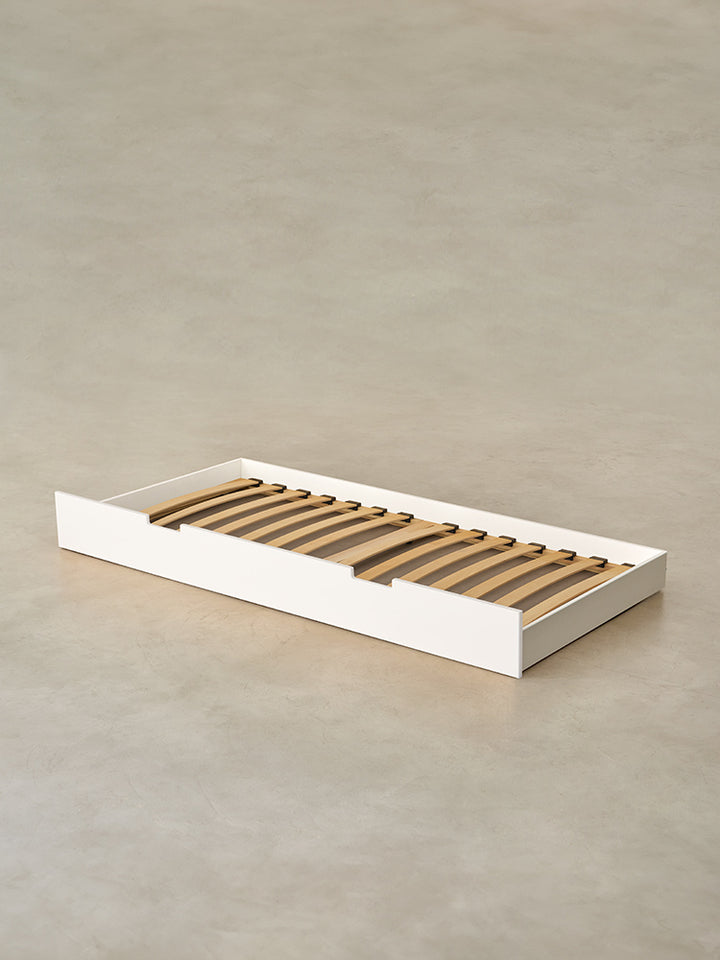 Cabania white children's bed with integrated storage drawer, ideal for minimalist bedroom.