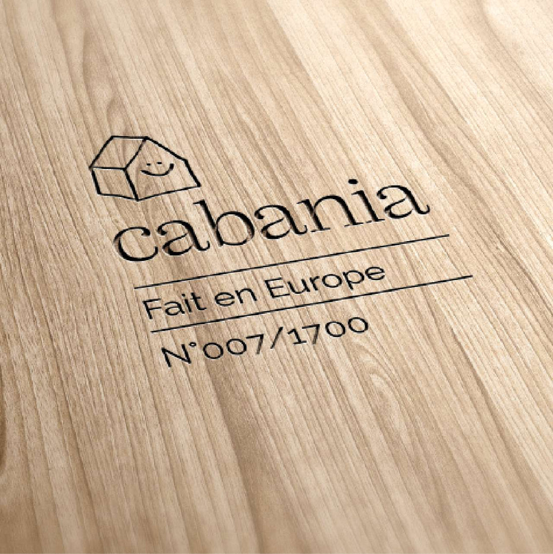 Wood engraving of the Cabania logo with the words 'Made in Europe' and a unique serial number. This mark authenticates the craftsmanship and quality of the materials used. The natural wood highlights the brand's commitment to sustainable, environmentally-friendly products, guaranteeing furniture designed to last for generations. Each piece is numbered, underlining the exclusivity and care given to each creation.