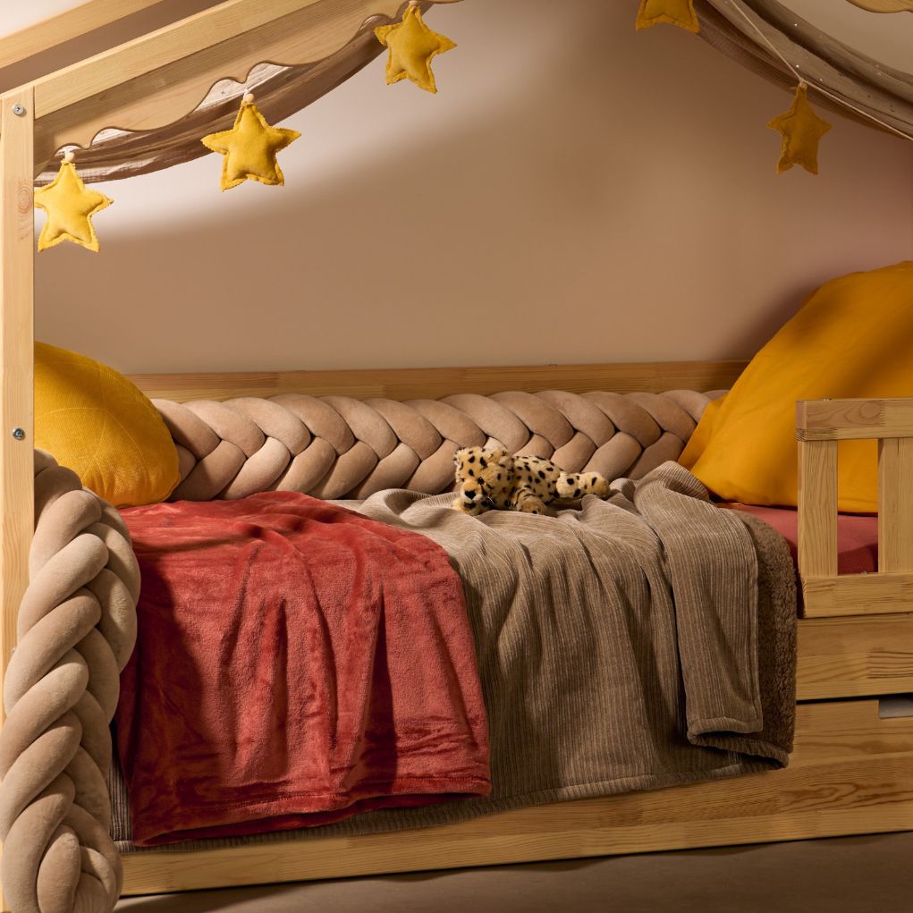 Beige baby braid on white Chamonix Montessori cabin bed, nursery.