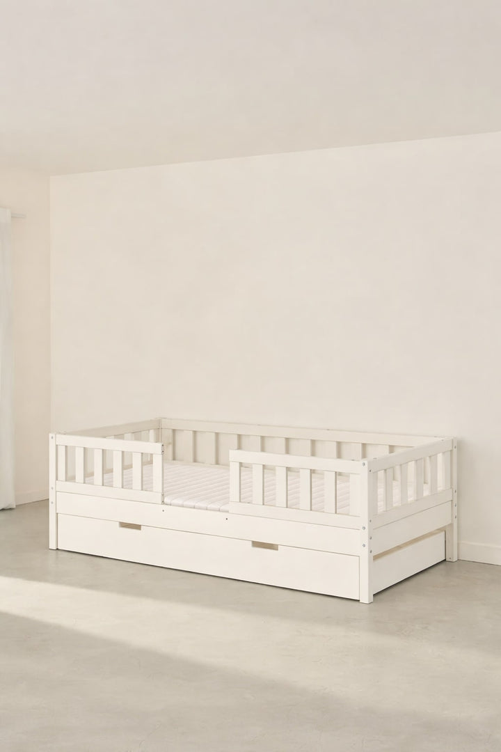 Barcelona white convertible children's bed with two barriers and built-in storage drawer.
