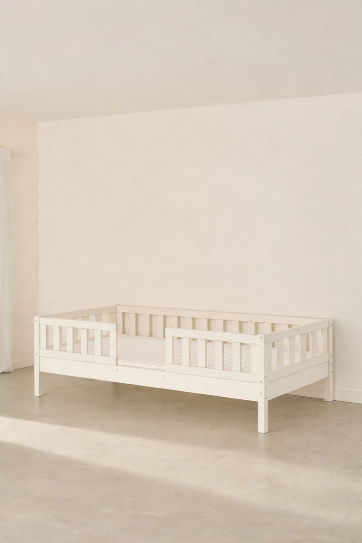 Barcelona white convertible children's bed with two classic barriers, modern and safe design.