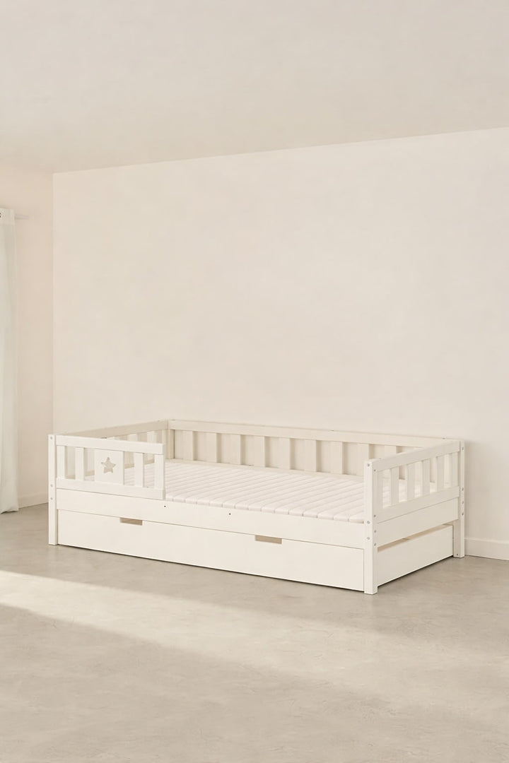 Barcelona white convertible children's bed with star guardrail and storage drawer.