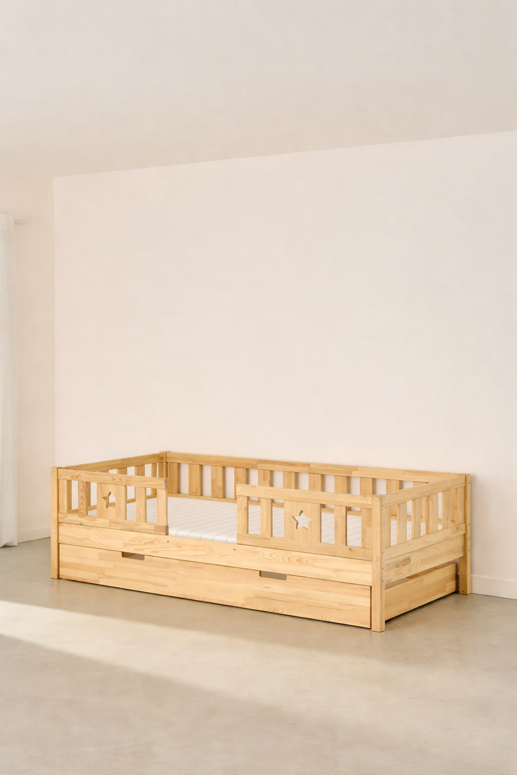 Barcelona natural convertible children's bed, two star-shaped barriers, storage drawer included.