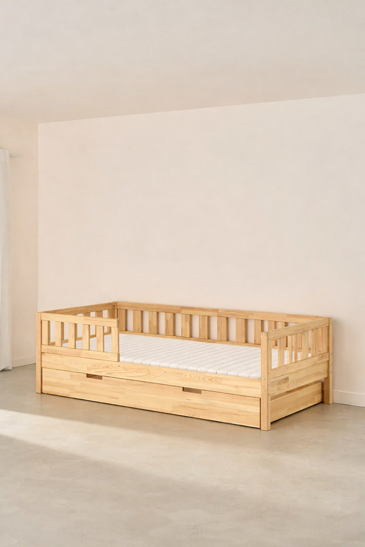 Barcelona natural convertible children's bed with classic guardrail and storage drawer, ideal for a modern nursery.
