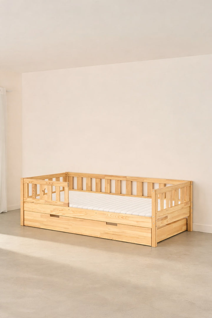 Barcelona natural convertible children's bed with star guardrail and built-in storage drawer.