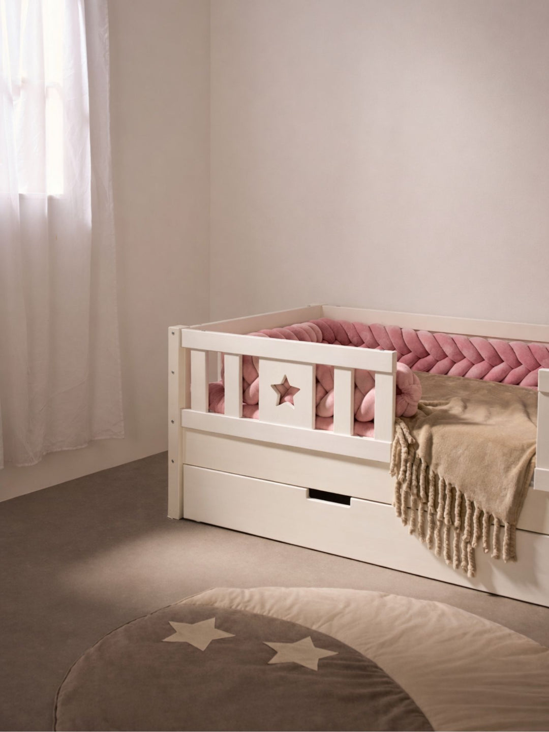 White Barcelona bed raised to 21 cm with large sliding storage drawer and star-shaped guardrail.