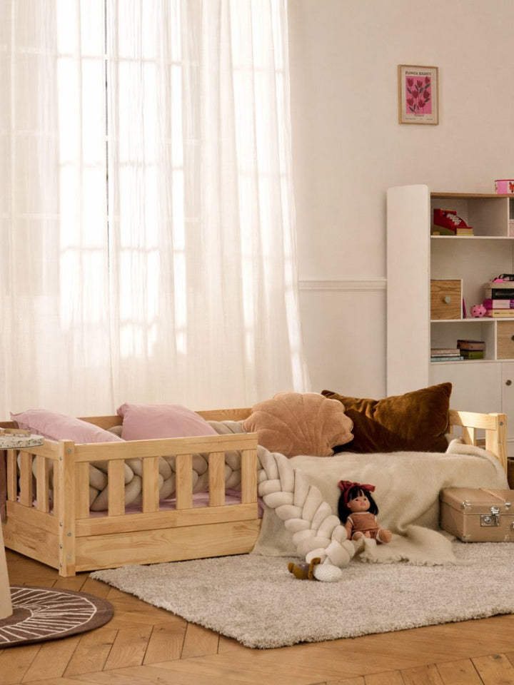 Barcelona Montessori bed in low position 1 cm from the floor for child independence. Natural wood with classic guardrail.